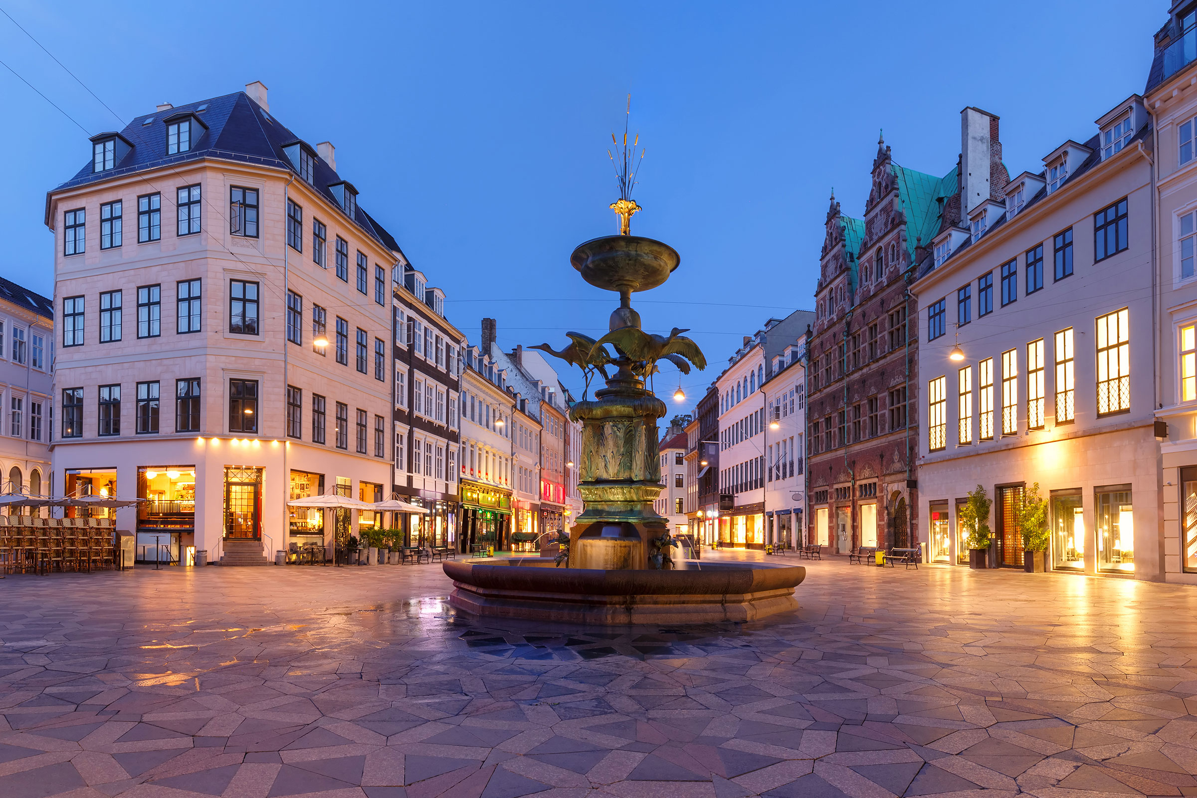 Stork Fountain on the Amagertorv square, Stroget street during morning blue hour, Copenhagen, capital of Denmark
