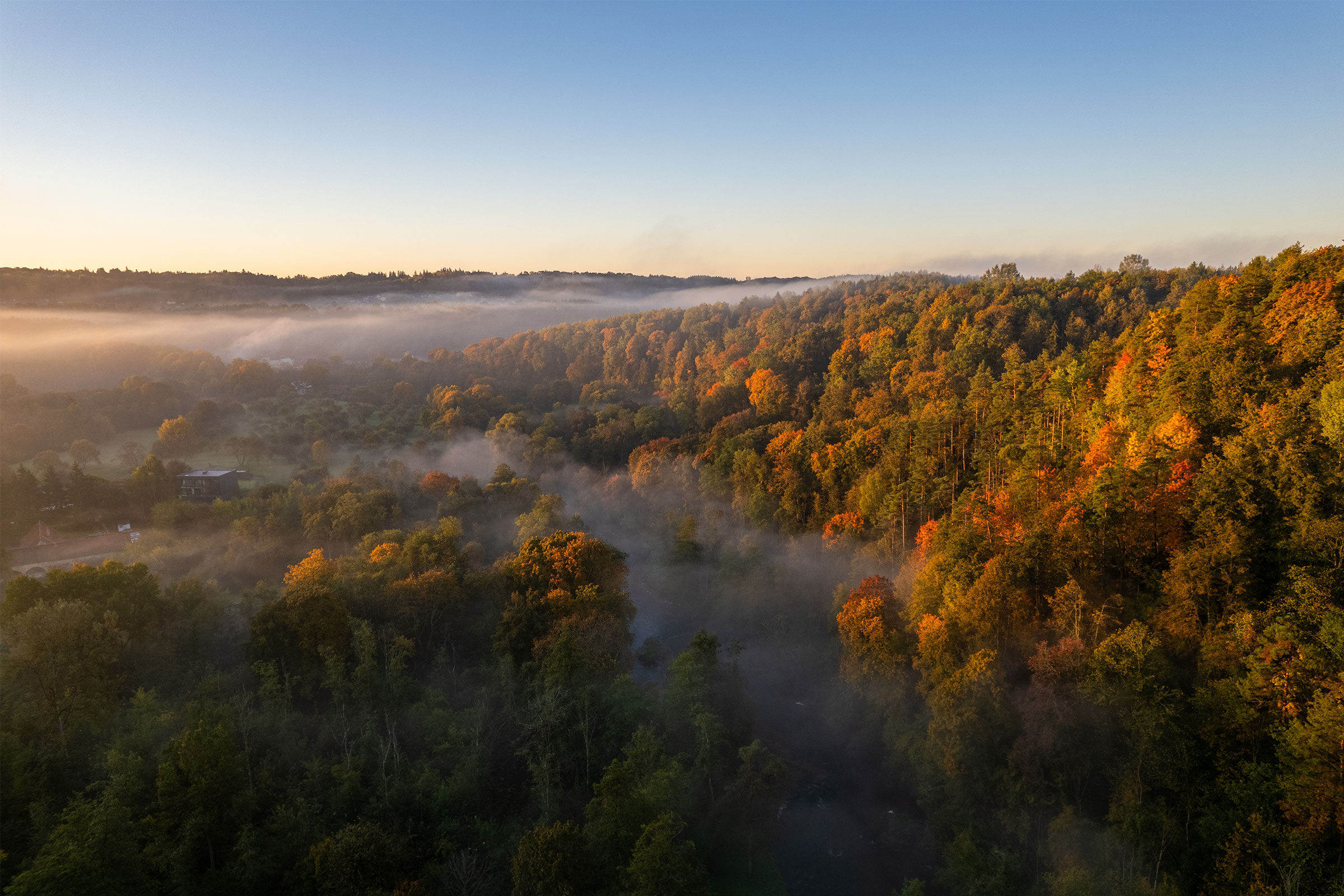 Aerial autumn fall sunrise view of foggy forest in Vilnius, Lithuania