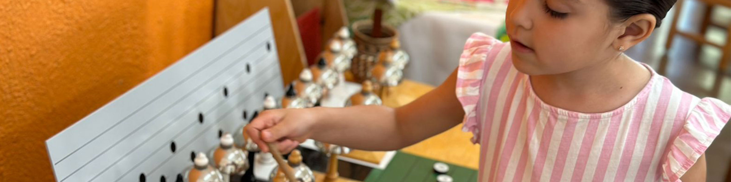 Child with Montessori bells material