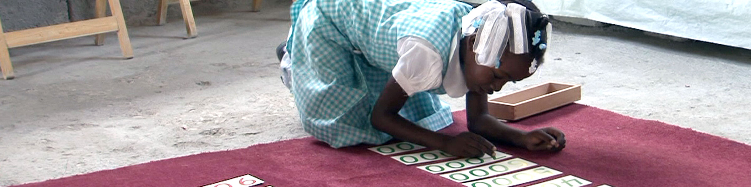 Child with decimal cards Montessori material