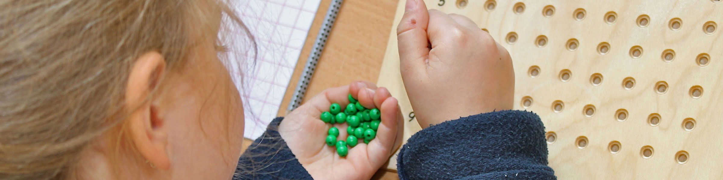 Child with Montessori maths material