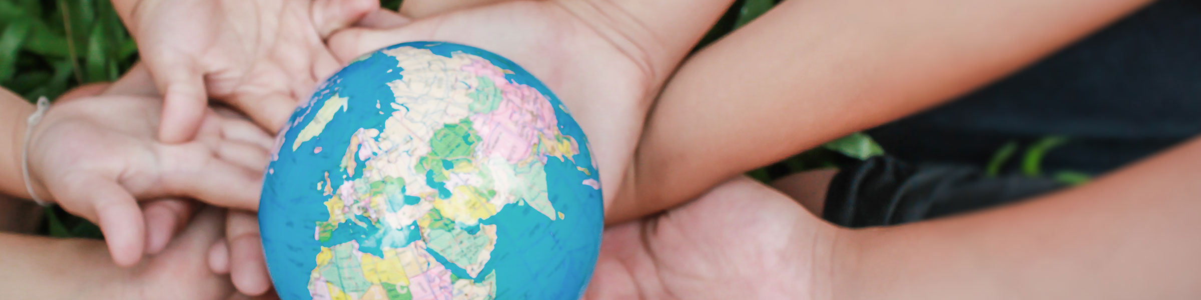 Children's hands holding globe