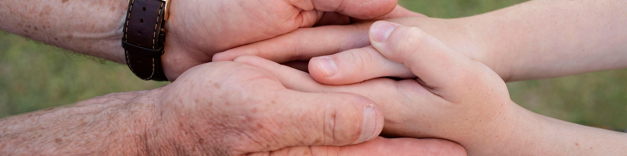 Adult and child hands clasped