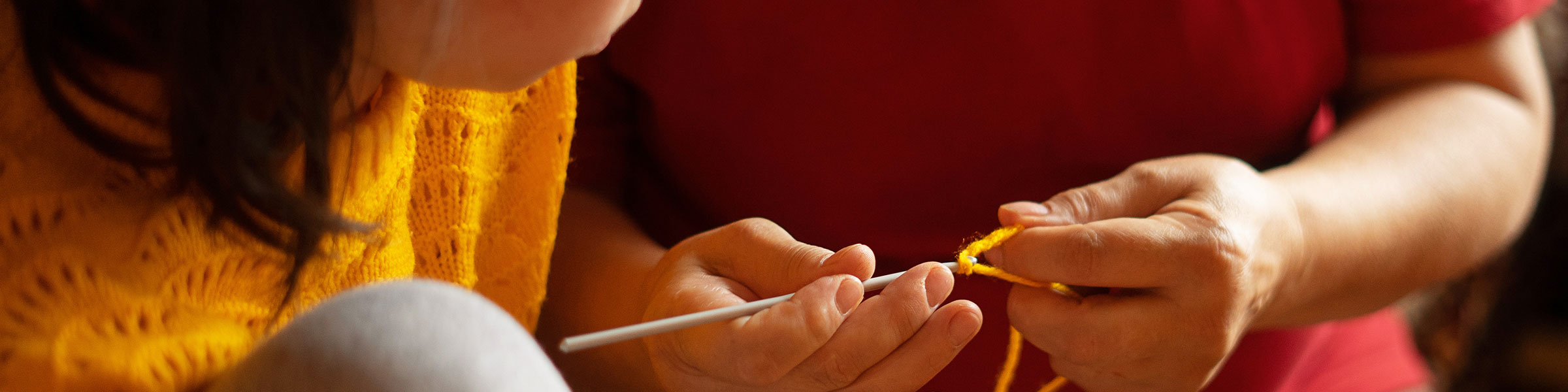 Child shown how to knit