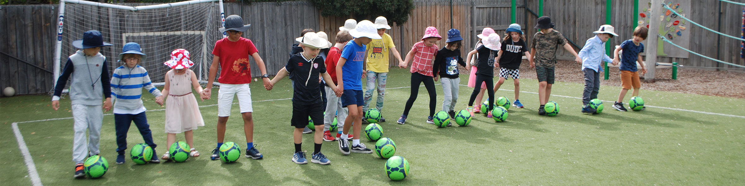 Line of children playing soccer