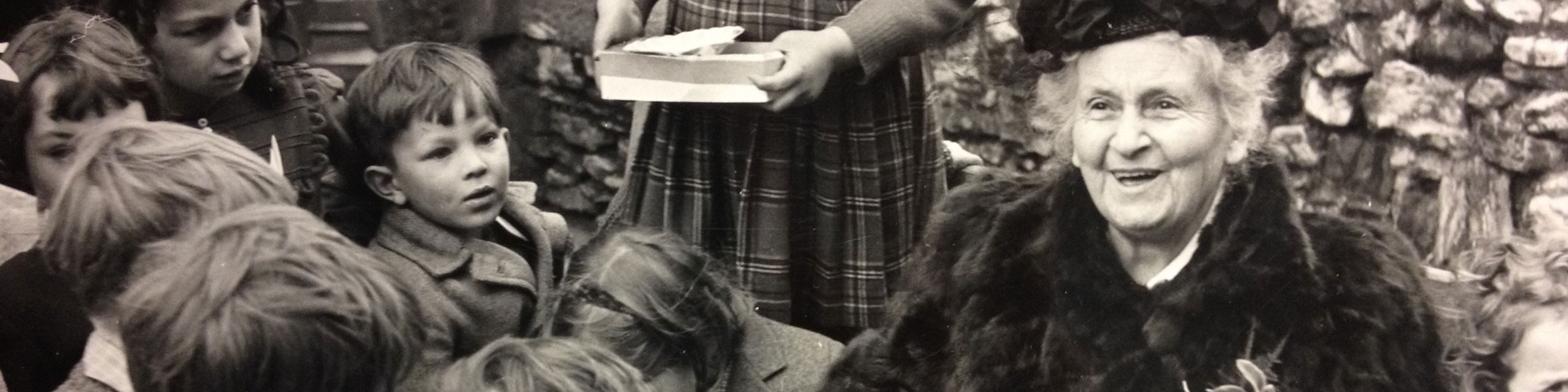Maria Montessori laughing with children