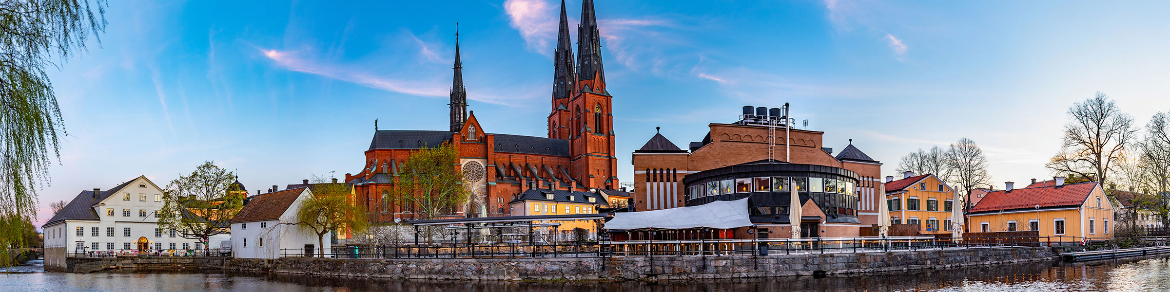 Sunset view of Uppsala cathedral reflecting on river Fyris in Sweden