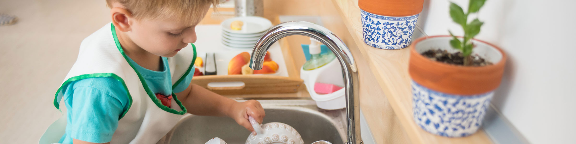 Child washing teapot