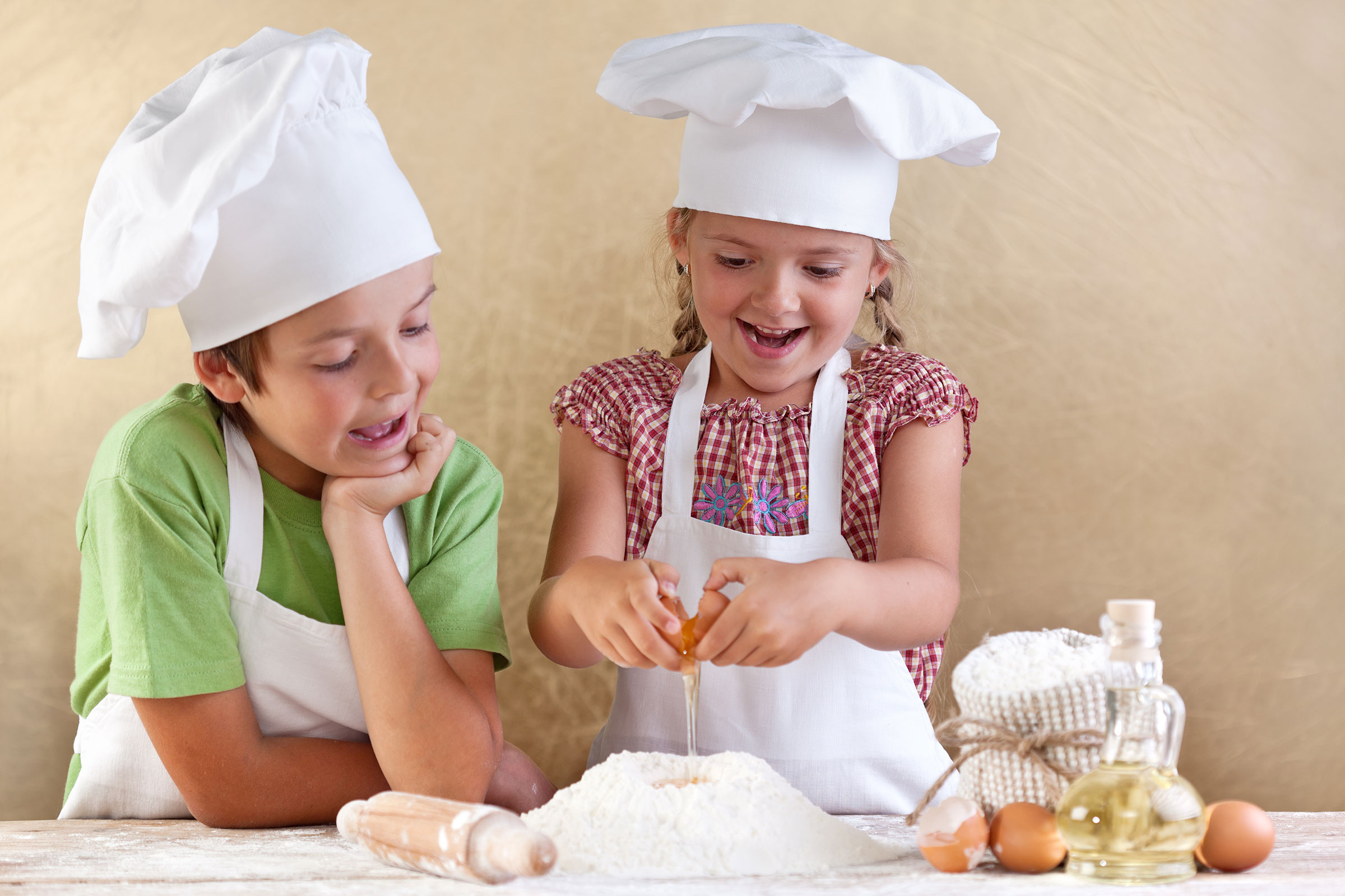 Children in a kitchen working with dough