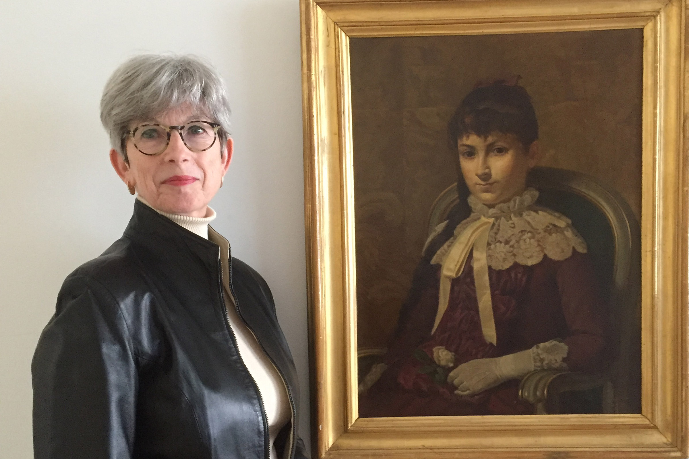 Helen Henny next to portrait of Maria Montessori