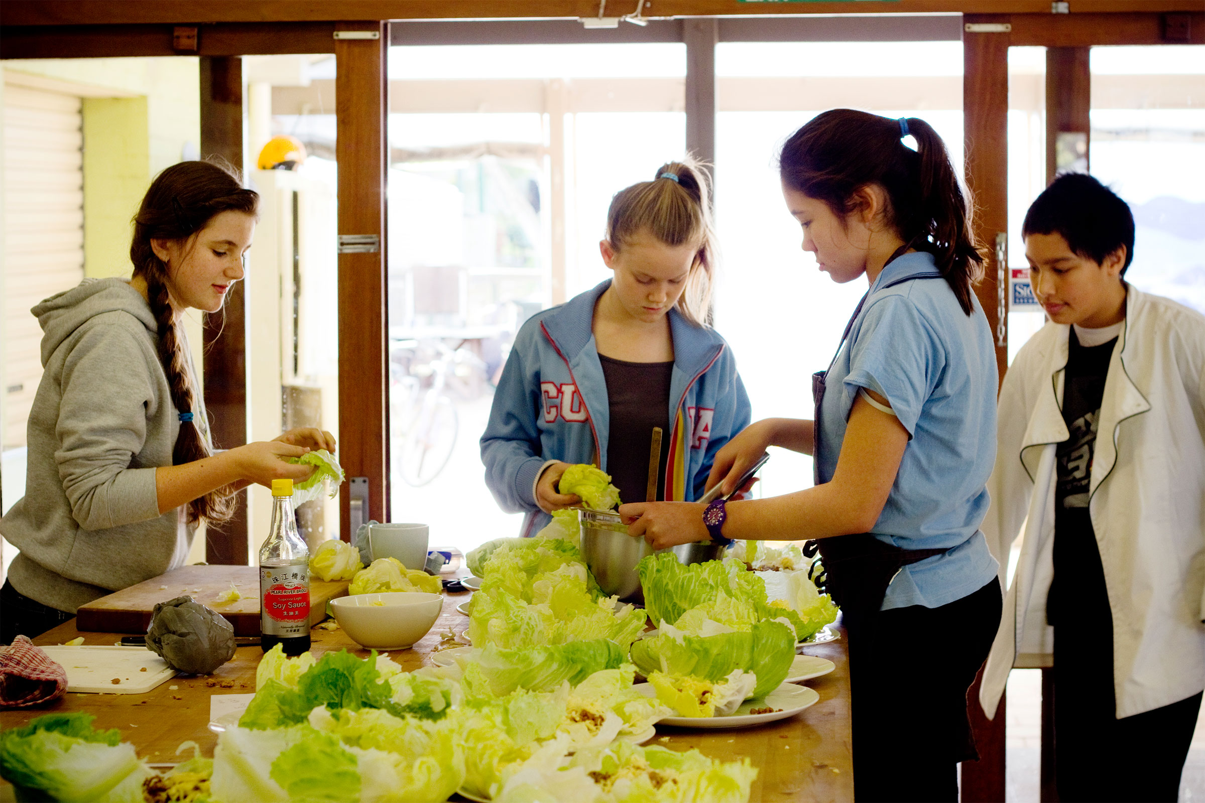 Group of adolescents cooking in a Montessori class