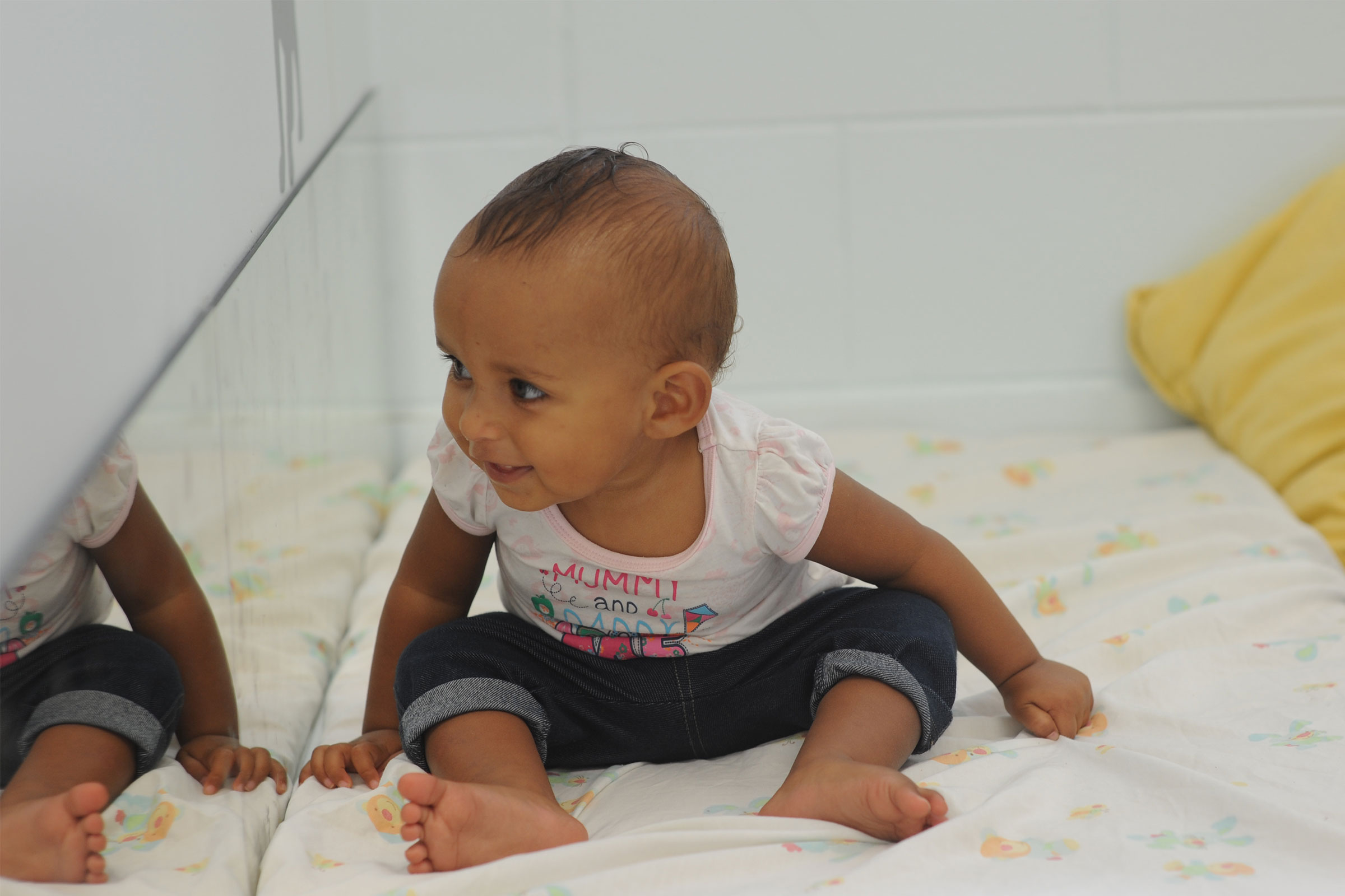 Baby looking into mirror