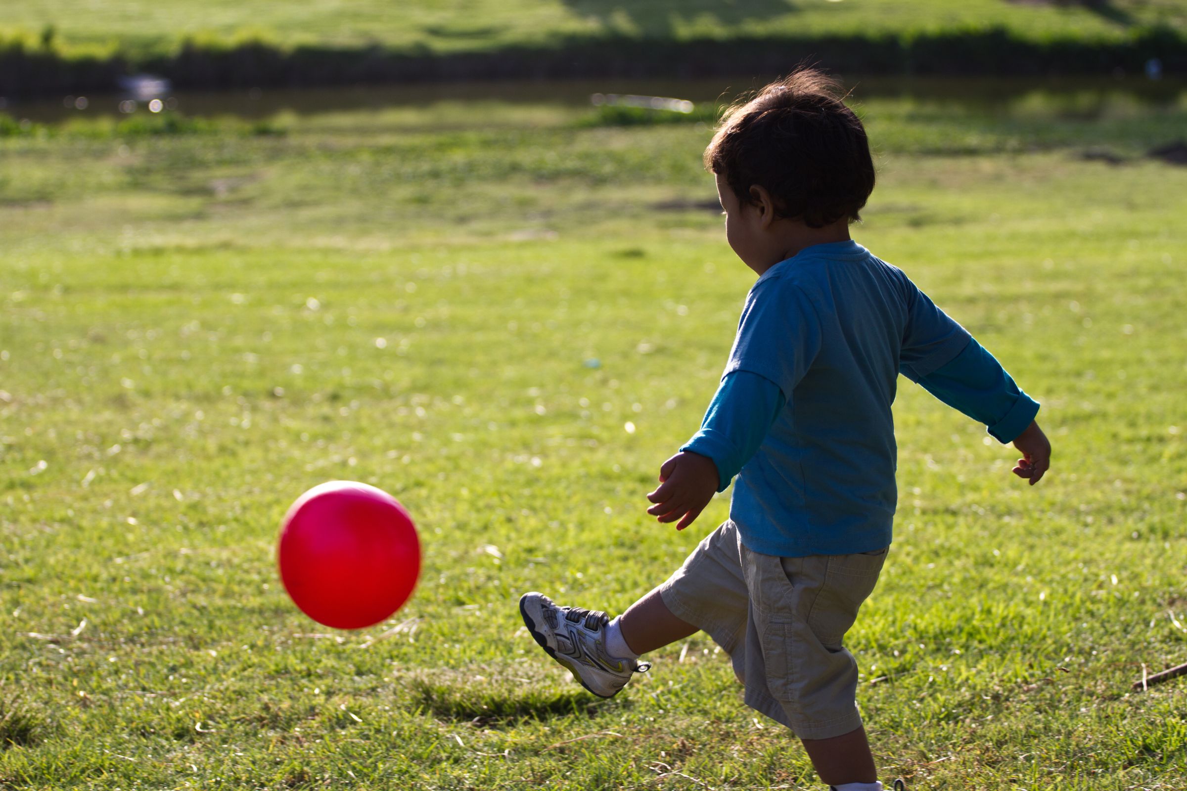 Small child kicking ball
