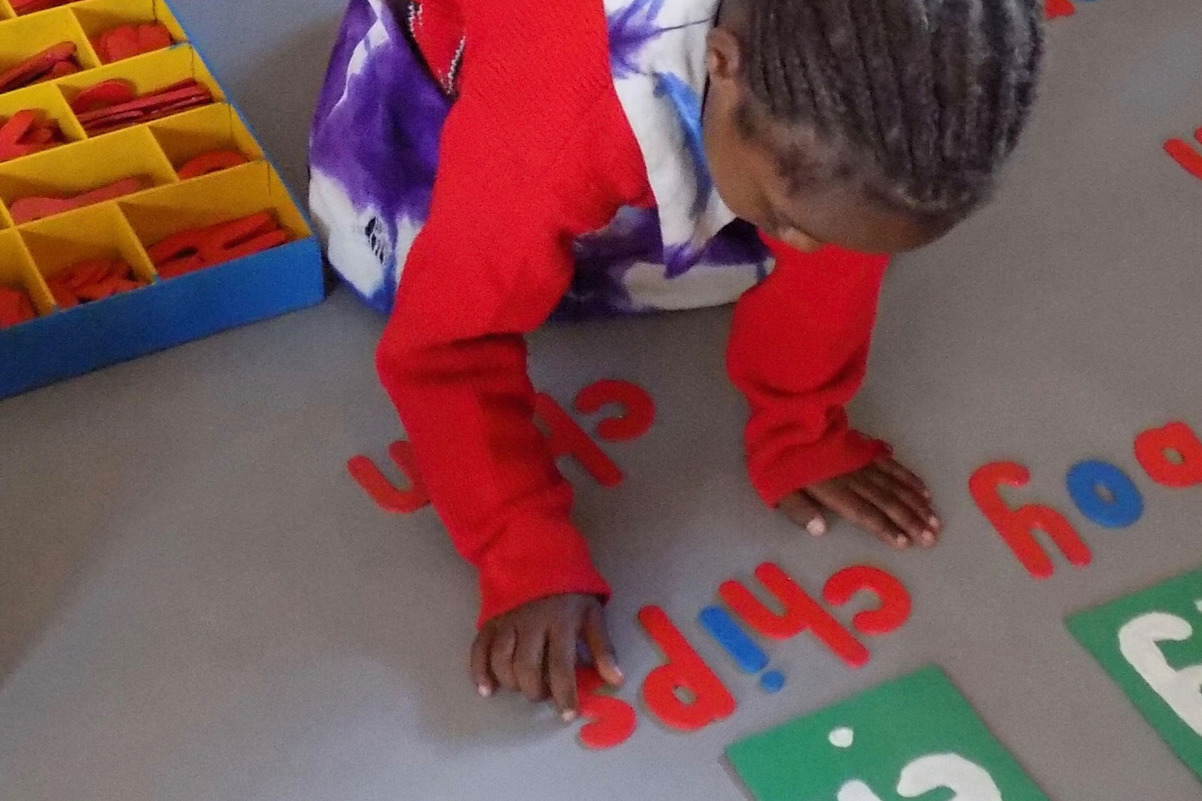 Child with moveable alphabet