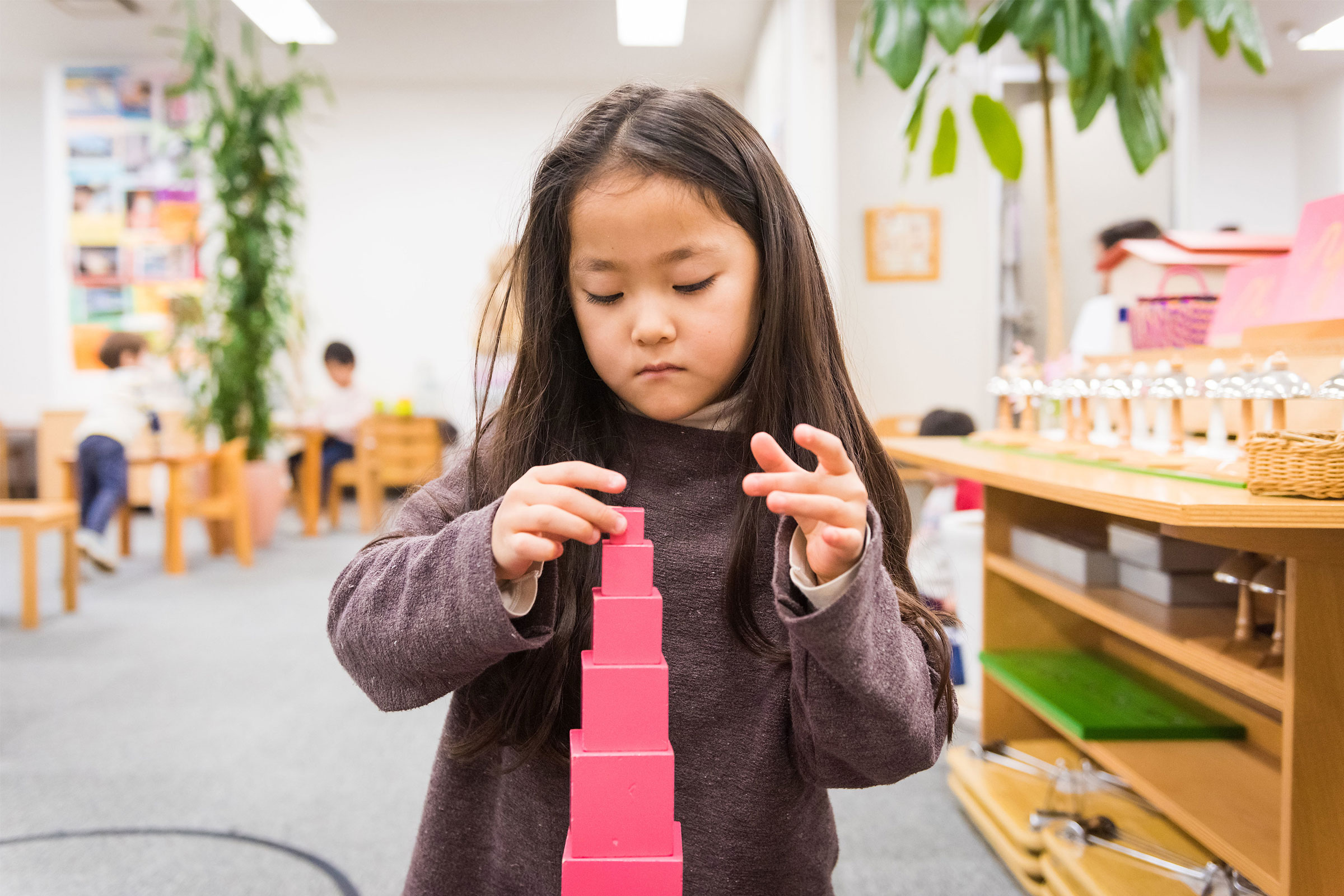 Child with Pink Tower material