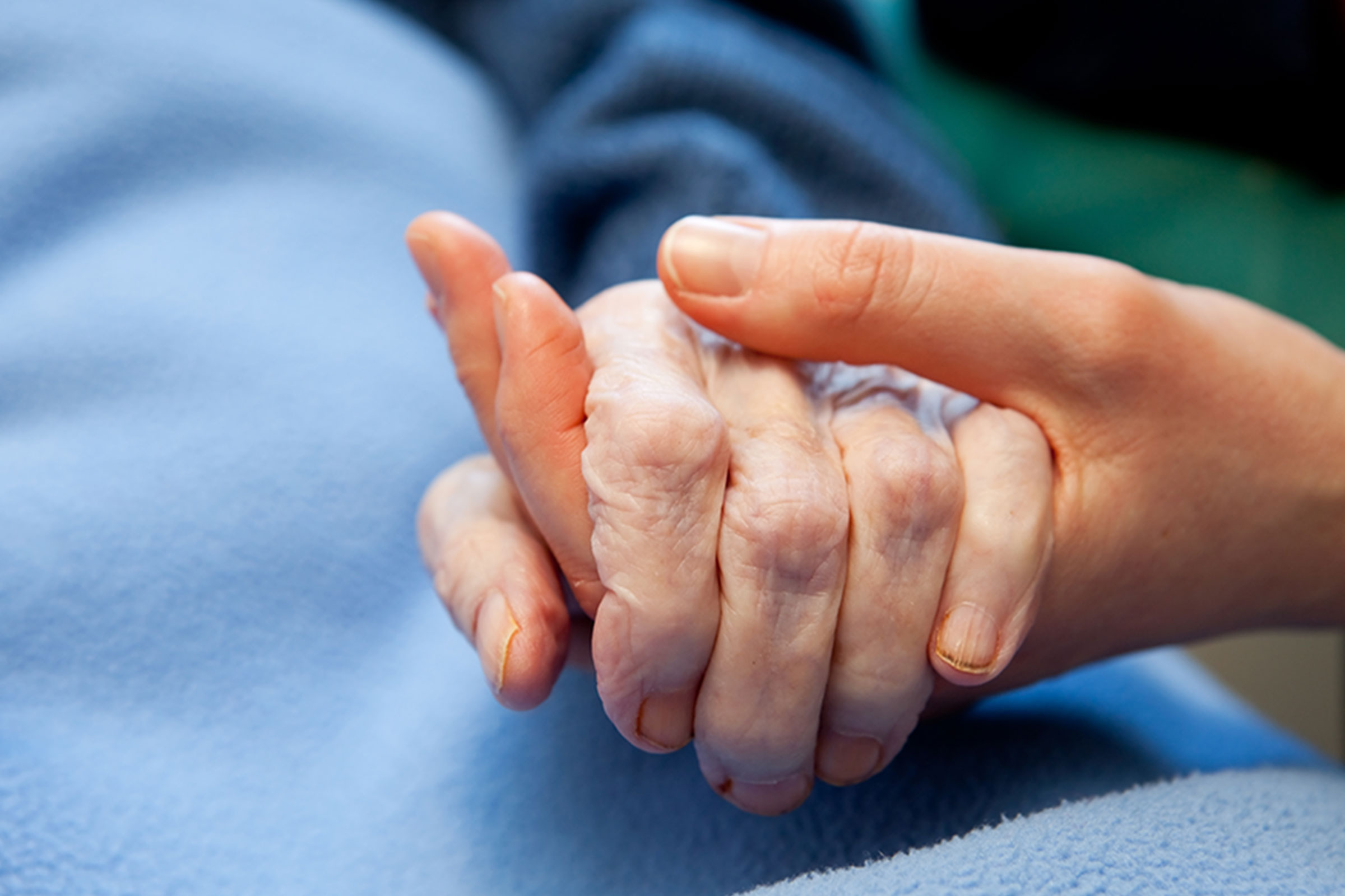 Holding elderly person's hand