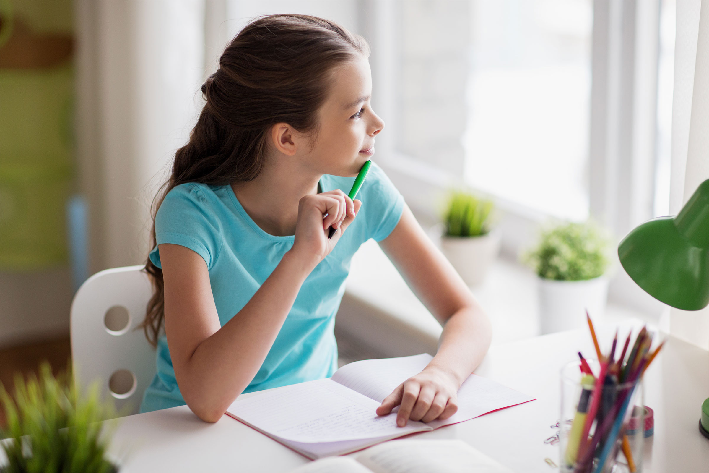 Girl at desk thinking