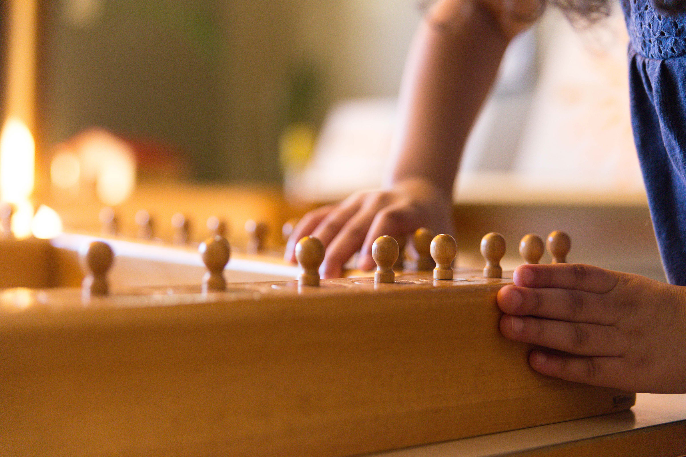 Child's hand on Montessori material