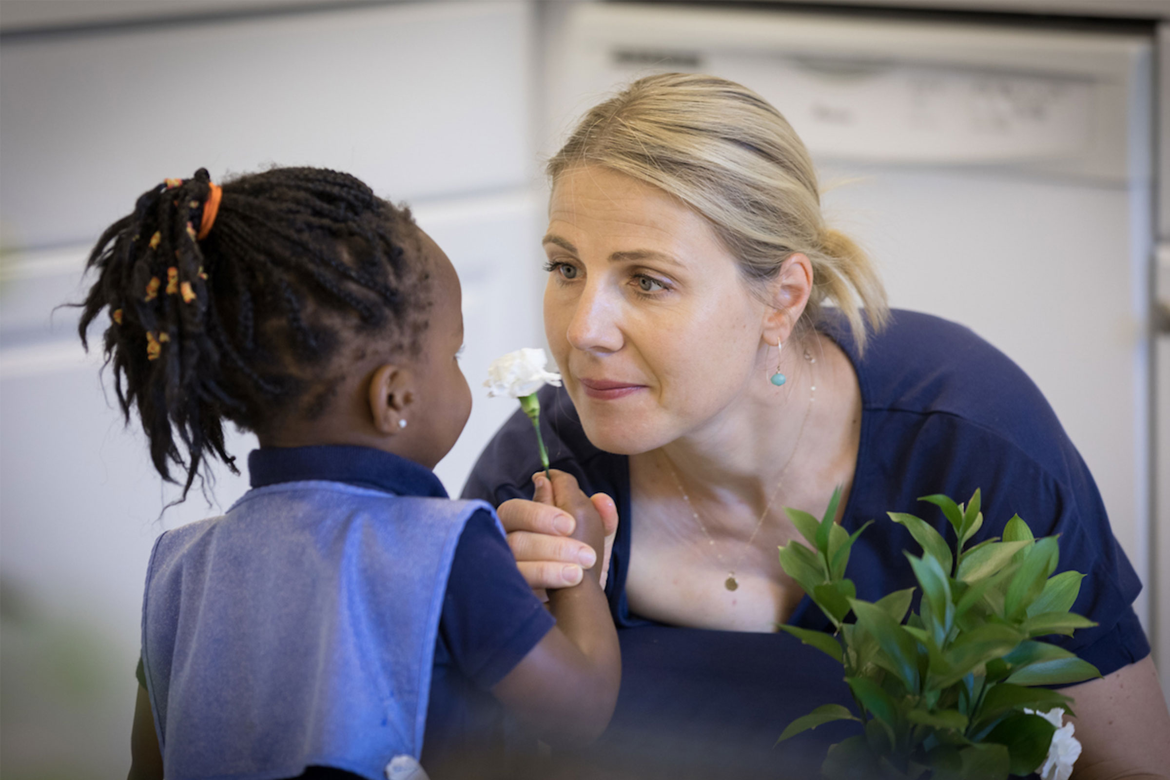 Child and teacher with flower