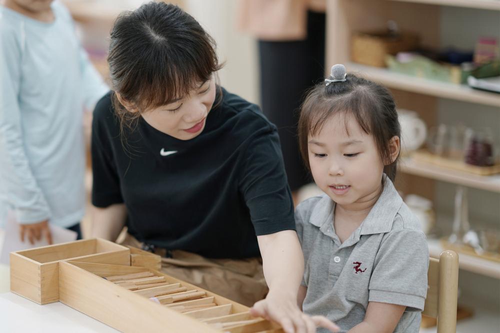Montessori teacher and child