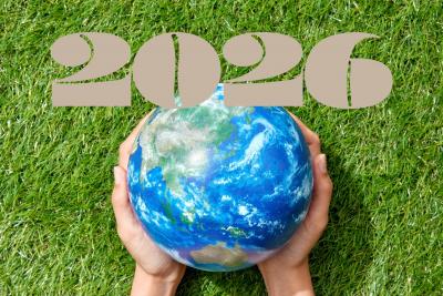 Hands holding globe with 2026