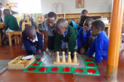 Children and teacher in Montessori classroom in Africa