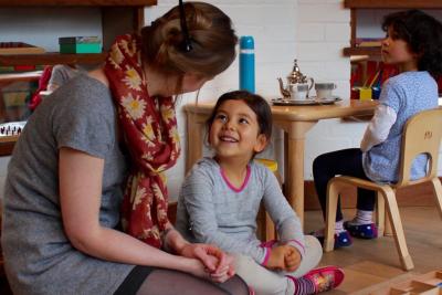 Child smiling up a teacher