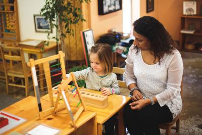 Child and teacher in a Montessori classroom